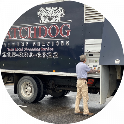 Watchdog Document Services employee loading bin of documents onto shred truck